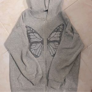 Grey jacket with butterfly shaped rhinestone